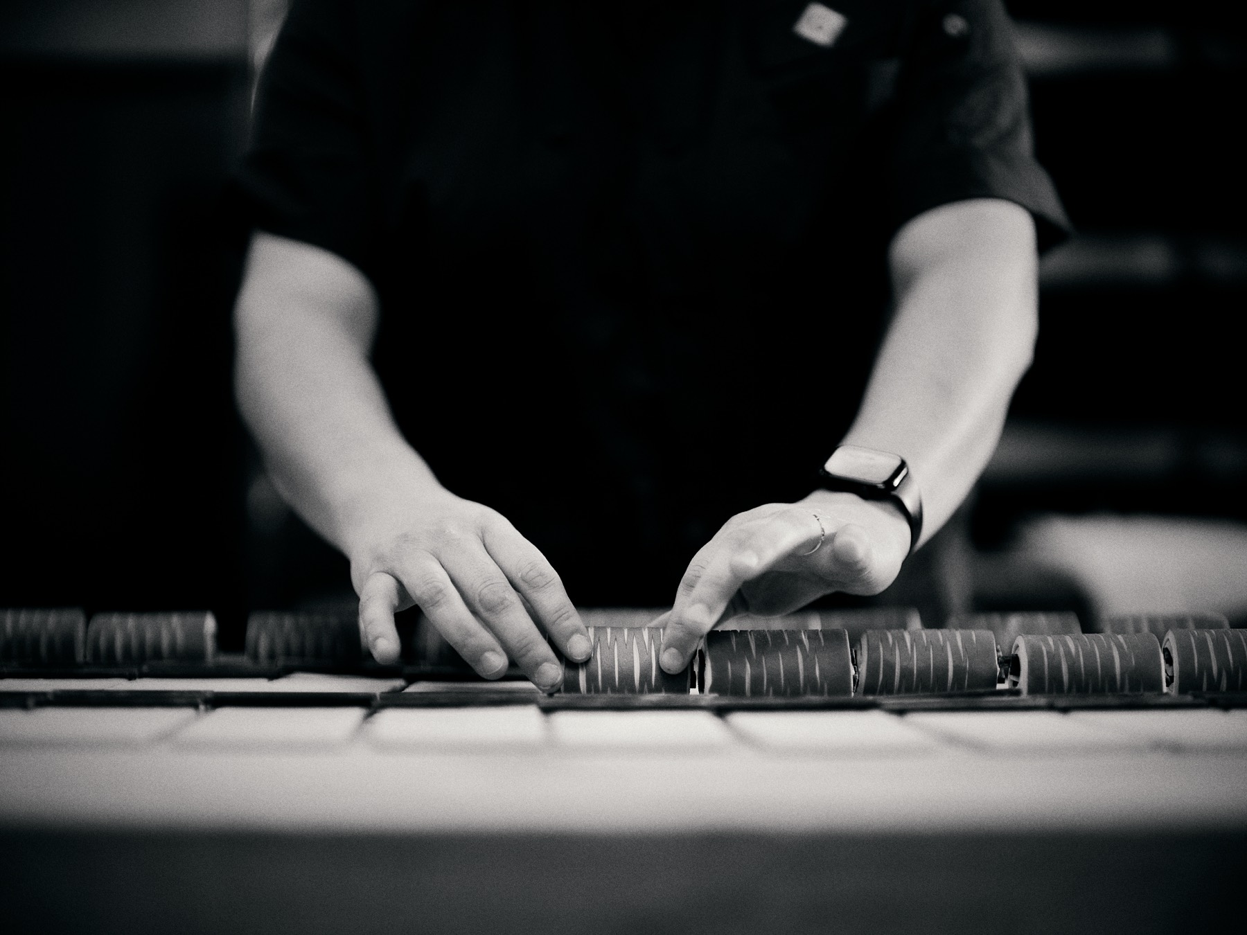 Baker shaping croissant dough by hand